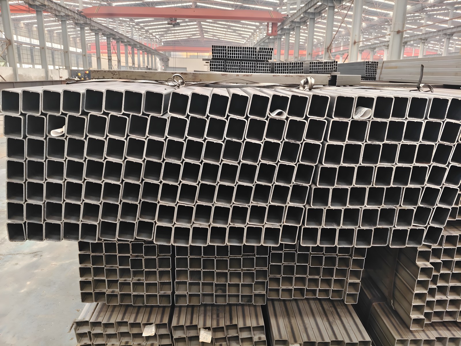 Punched bus-frame square tube bundles — end-face view in the production hall