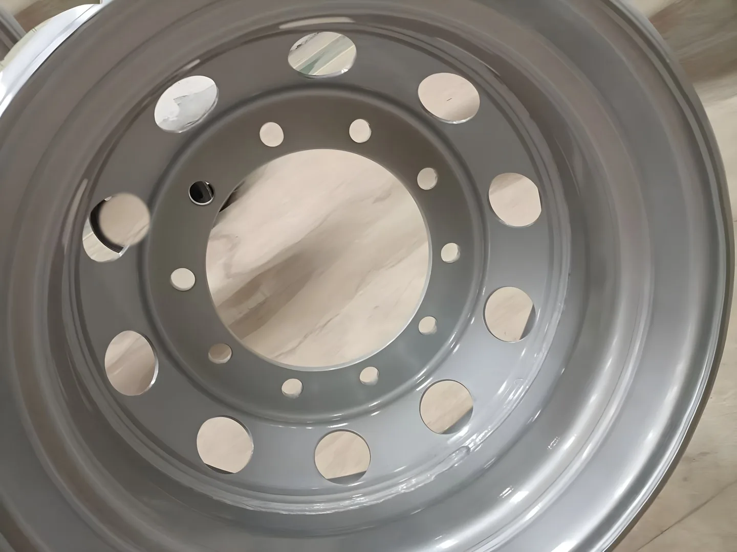 Bolt-hole and disc detail on a tubeless truck steel wheel